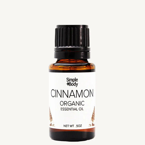 Bottle of Simple Body Cinnamon Organic Essential Oil on a white background