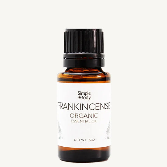 Bottle of Simple Body Frankincense Organic Essential Oil on a white background