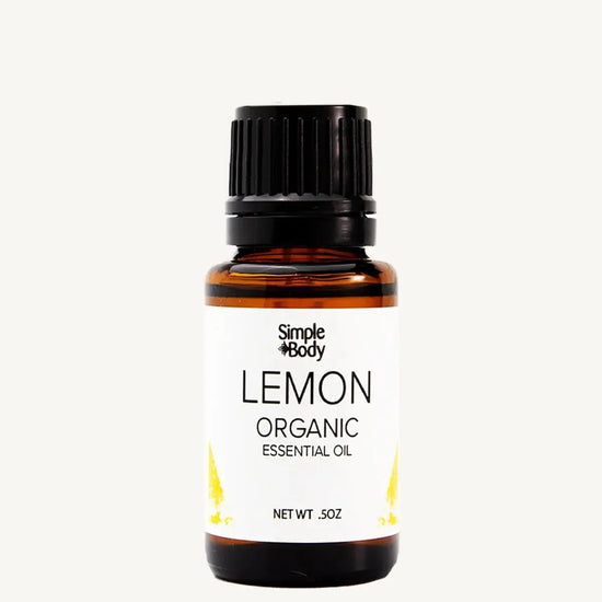 Bottle of Simple Body Lemon Organic Essential Oil on a white background