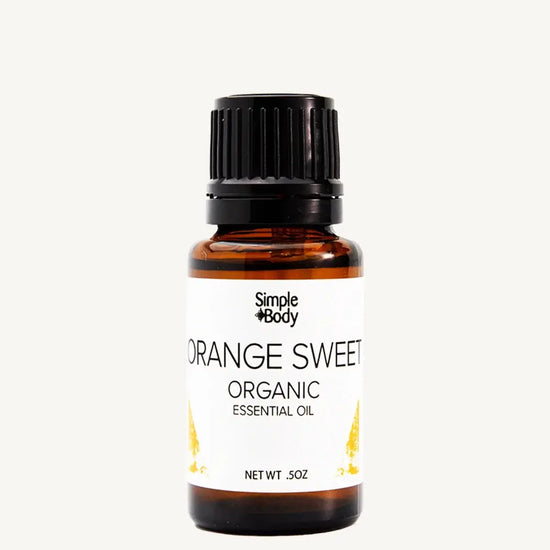 Bottle of Simple Body Orange Sweet Organic Essential Oil on a white background
