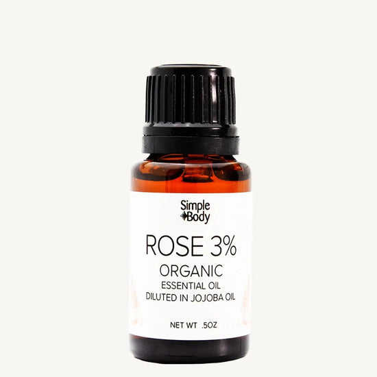 Bottle of Simple Body Rose 3% Organic Essential Oil on a white background