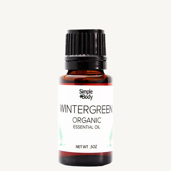 Bottle of Simple Body Wintergreen Organic Essential Oil on a white background