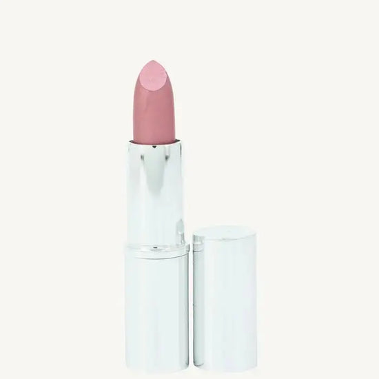 A photo of Pure Anada's Lip Stick in Prestige which is a Pink Shimmery hue in a  silver metallic tube on a tan background.
