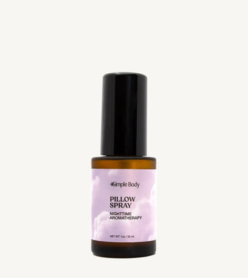 A small amber colored mist bottle labeled Pillow Spray with purple and white color label, indicating it is a nighttime aromatherapy product.