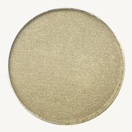 A photo of Pure Anada's Pressed Eye Color in Mirage which is a silvery gray-green color on a tan background.