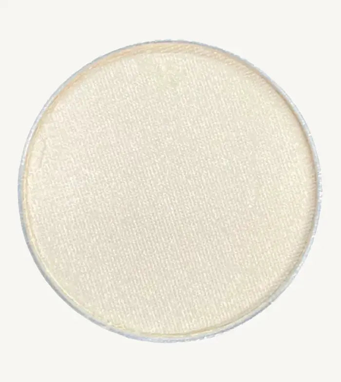 A photo of Pure Anada's Pressed Eye Color in Whisper which is an off-white color on a tan background.