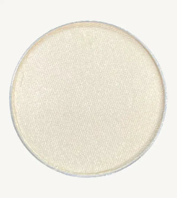 A photo of Pure Anada's Pressed Eye Color in Whisper which is an off-white color on a tan background.