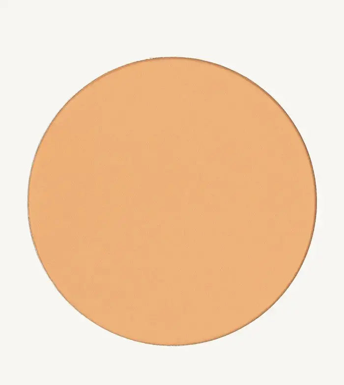 A photo of Pure Anada's Pressed Sheer Matte Foundation Powder in Light which is a warm beige color on a tan background.