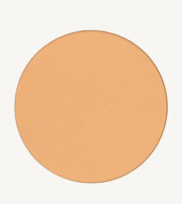 A photo of Pure Anada's Pressed Sheer Matte Foundation Powder in Light which is a warm beige color on a tan background.