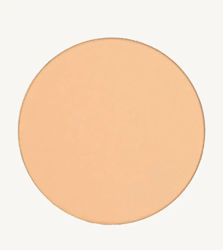 A photo of Pure Anada's Pressed Sheer Foundation in Very Fair which is a medium beige with light overtones and a warm feel on a tan background.