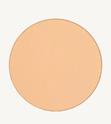 A photo of Pure Anada's Pressed Sheer Foundation in Very Fair which is a medium beige with light overtones and a warm feel on a tan background.