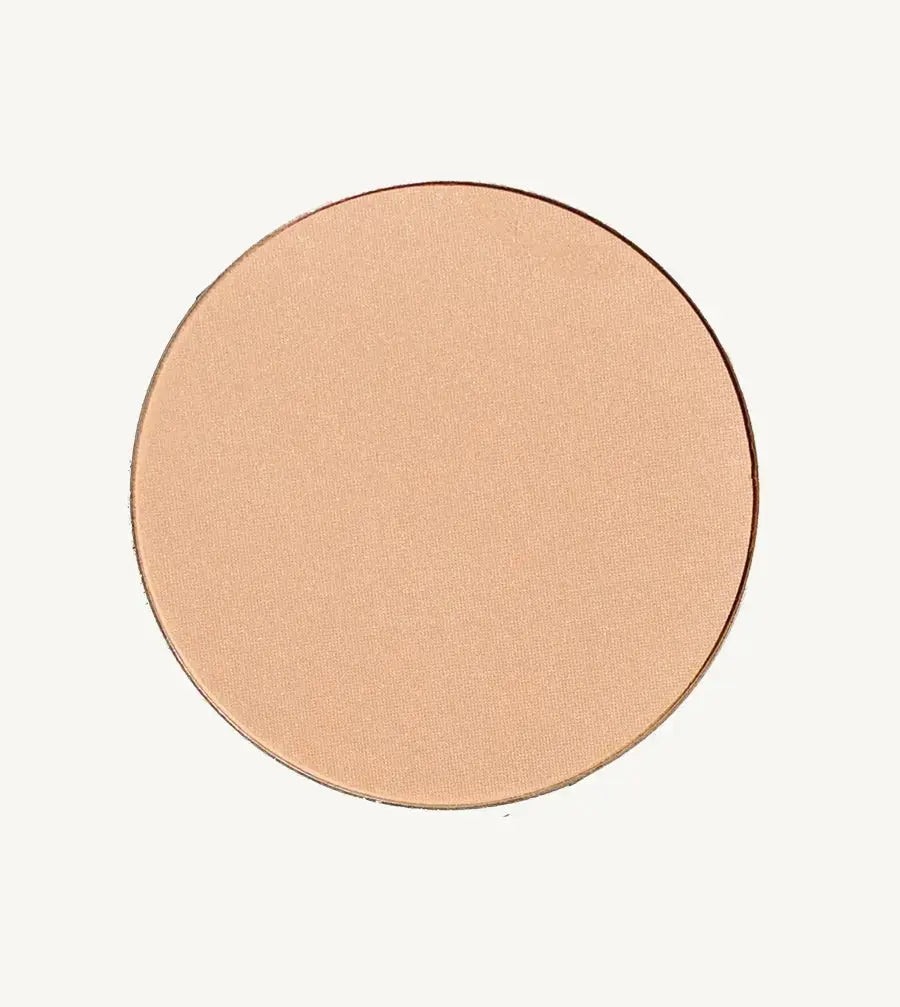 A photo of Pure Anada's Pressed Translucent Finishing Powder in Glow which is a warm peach with a slight shimmer on a tan background.