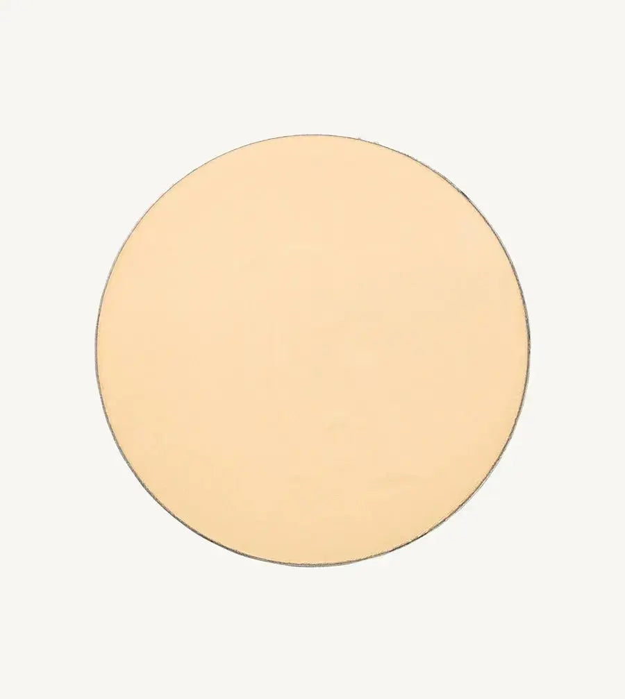 A photo of Pure Anada's Pressed Translucent Setting Powder in Matte which is a light yellow / pink color on a tan background.