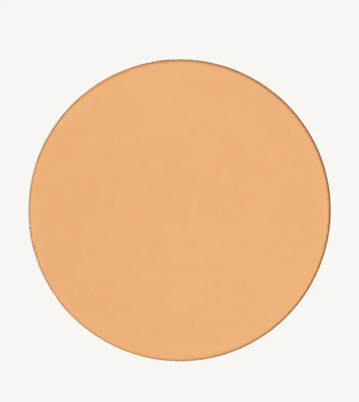 A photo of Pure Anada's Pressed Sheer Matte Foundation Powder in Light which is a warm beige color on a tan background.