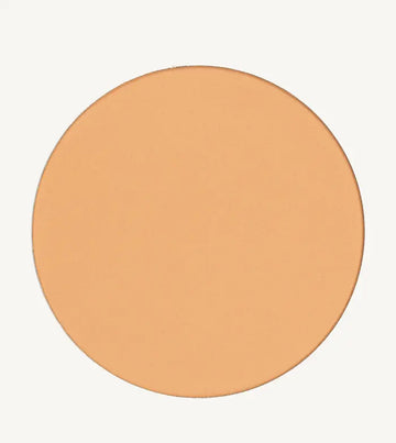 A photo of Pure Anada's Pressed Sheer Matte Foundation Powder in Light which is a warm beige color on a tan background.