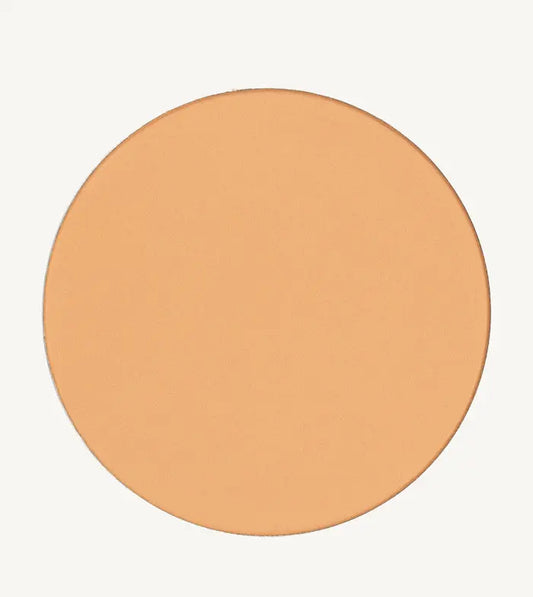 A photo of Pure Anada's Pressed Sheer Matte Foundation Powder in Light which is a warm beige color on a tan background.