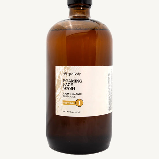 Brown bottle of Simple Body foaming face wash refill in Chamomile for Calm and Balance and Soothing on a white background