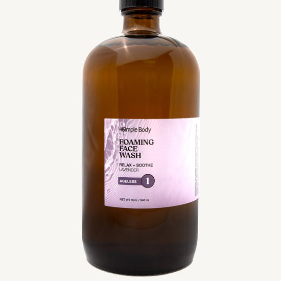 Brown bottle of Simple Body's foaming face wash refill in Lavender for relaxing and soothing with a purple label on a white background