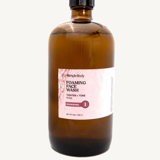 Brown bottle of Simple Body foaming face wash  in Rose for Tightening and Toning on a white background