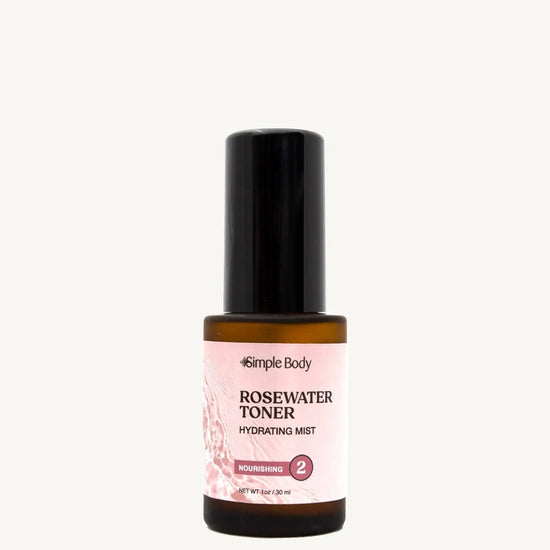 A bottle of Rosewater Face Toner by Simple Body. The bottle is amber transparent with a black cap.