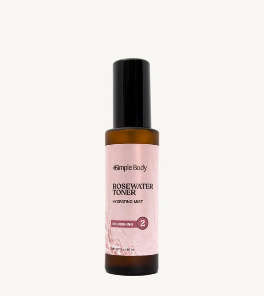 A bottle of Rosewater Face Toner by Simple Body. The bottle is amber transparent with a black cap.