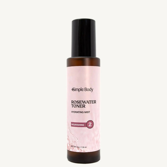 A bottle of Rosewater Face Toner by Simple Body. The bottle is amber transparent with a black cap.