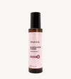 A bottle of Rosewater Face Toner by Simple Body. The bottle is amber transparent with a black cap.