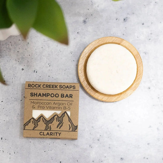 Rock Creek Soaps shampoo bar with packaging on a textured surface