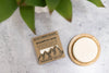 Rock Creek Soaps shampoo bar with packaging on a concrete surface