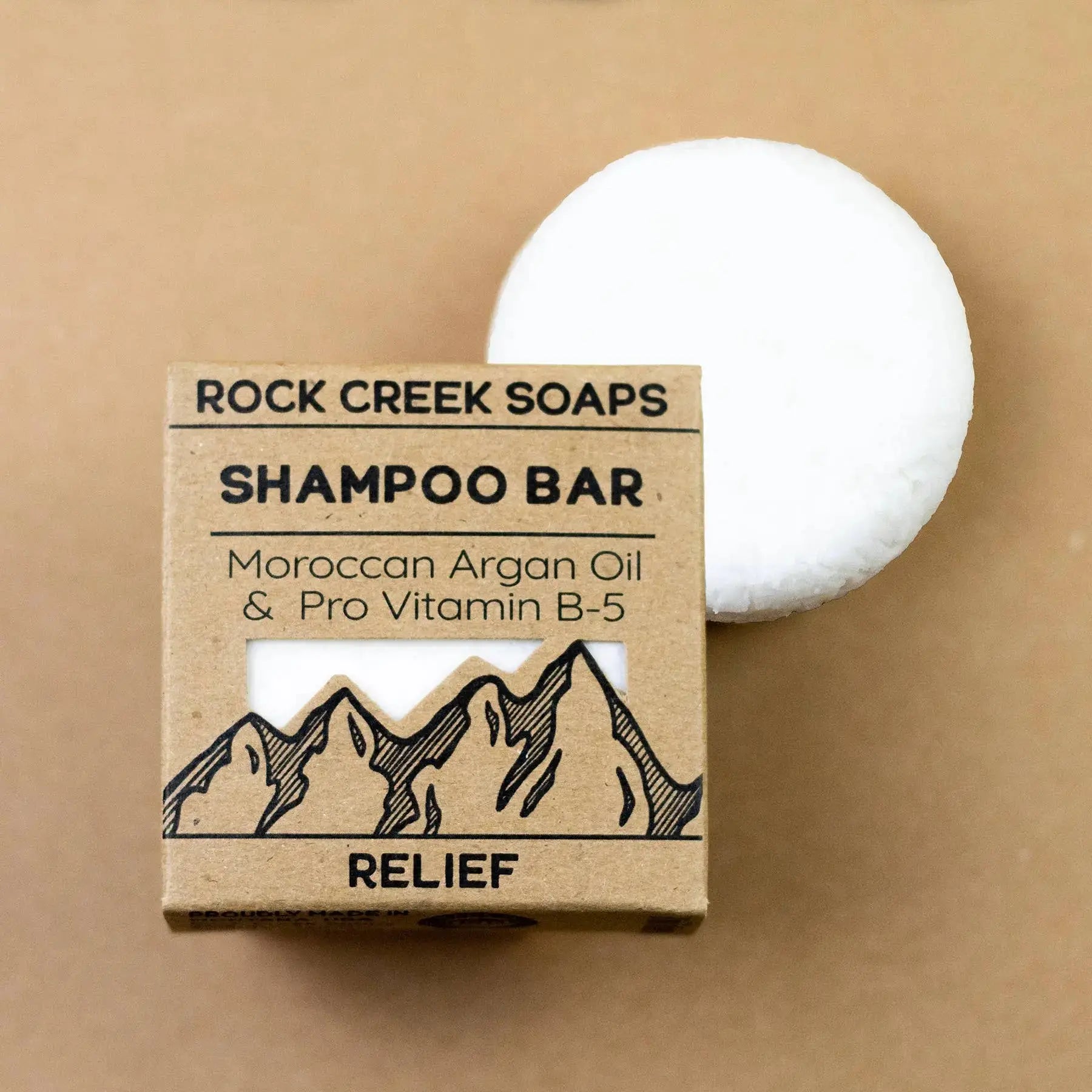 Rock Creek Soaps shampoo bar with packaging on a beige background