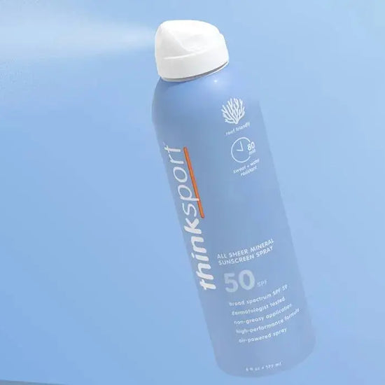 thinksport sunscreen spray bottle on a light blue background