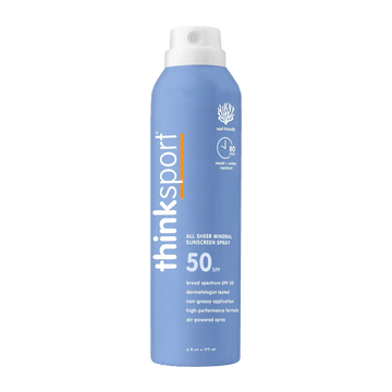 Blue sunscreen spray bottle with white cap on a white background