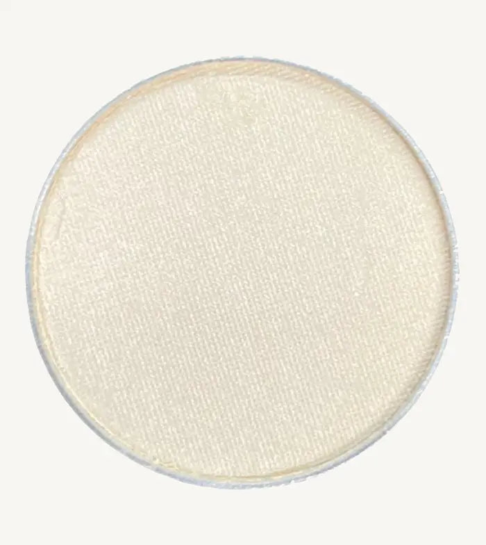 A photo of Pure Anada's Pressed Eye Color in Whisper which is an off-white color on a tan background.