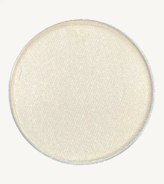 A photo of Pure Anada's Pressed Eye Color in Whisper which is an off-white color on a tan background.