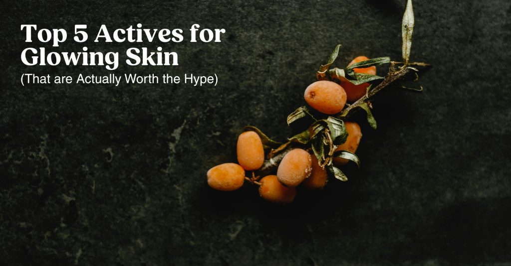 A photo of a small branch with sea buckthorn berries on it and the title of our blog post "Top 5 Actives for Glowing Skin -- that are worth the hype"