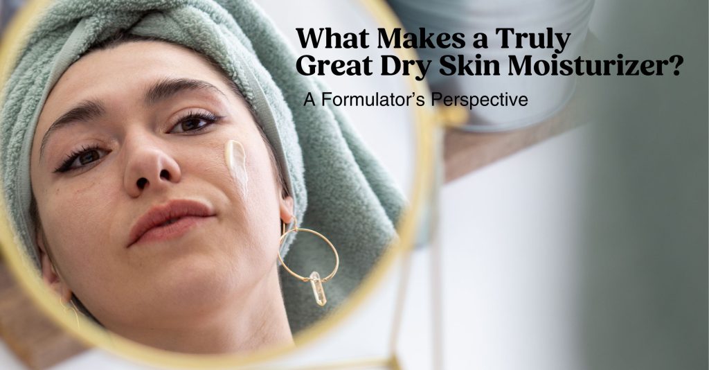 A photo of Sara looking in the mirror with a green towel wrapped around her head and a swipe of face cream on her cheek