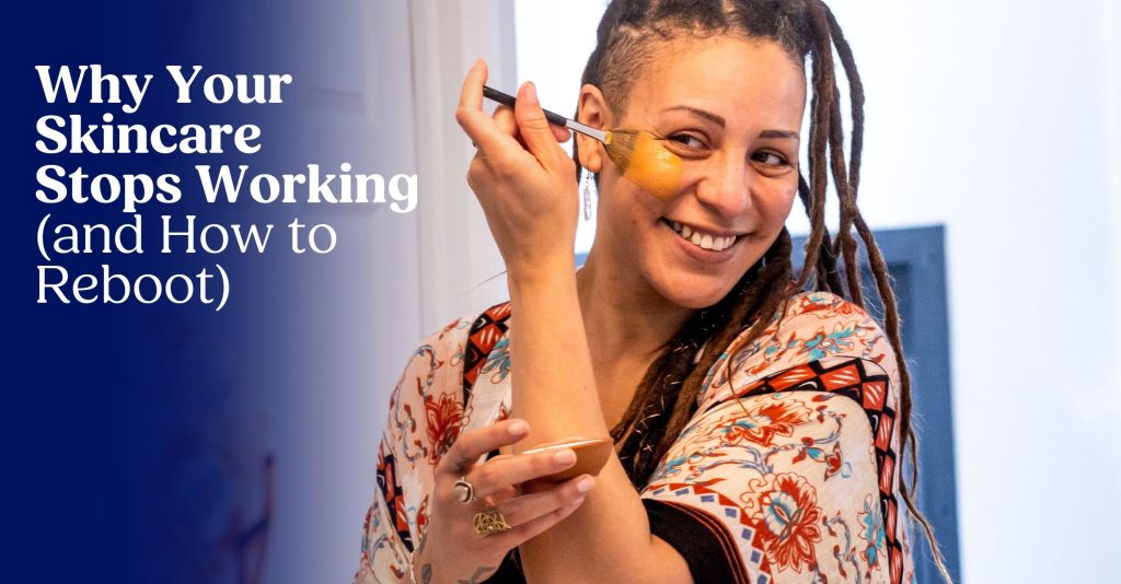 An image of a woman with dreadlocks applying a mask to her face