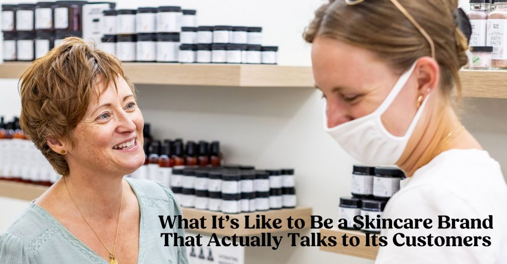 A photo of Jewels speaking with a customer who is wearing a white medical mask.
